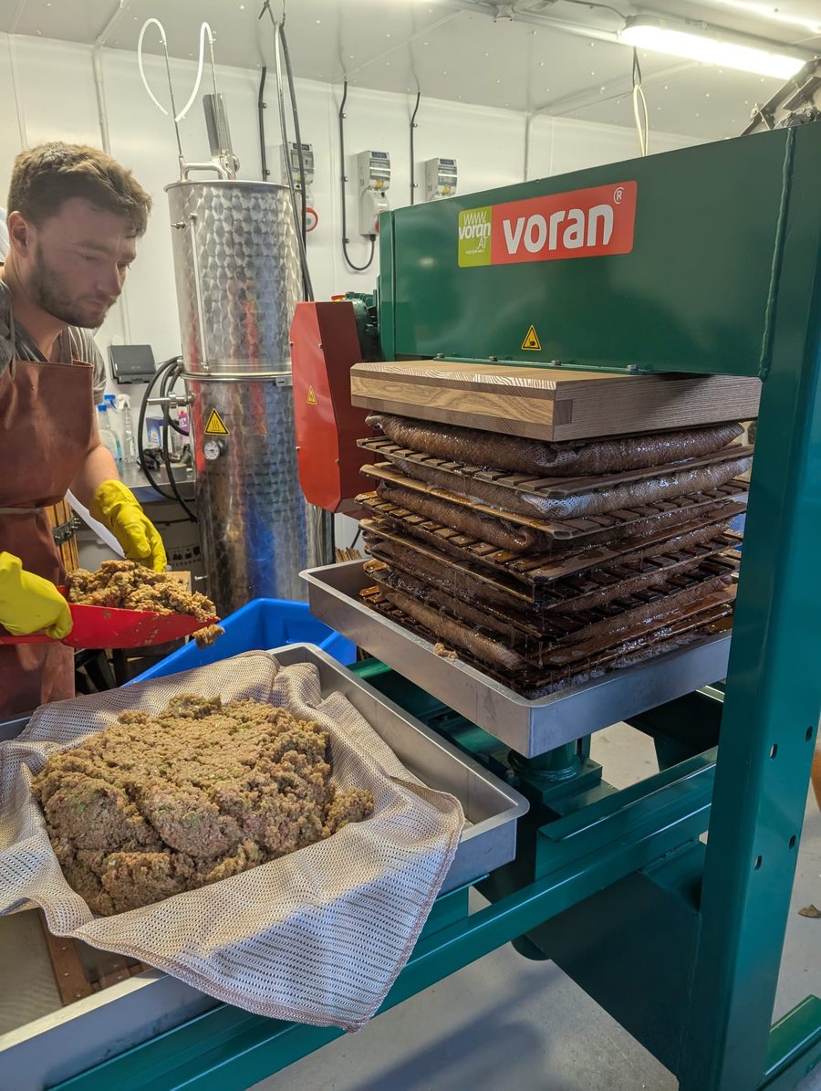 Building the cheeses on the press in the cidery